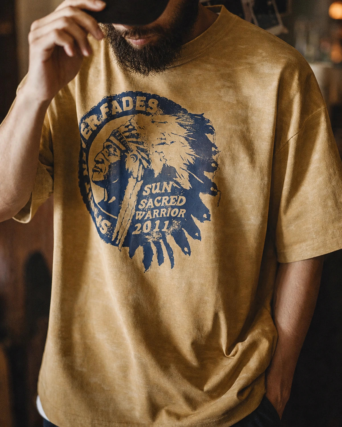 Man wearing the washed mustard amekaji tee with vintage Americana print