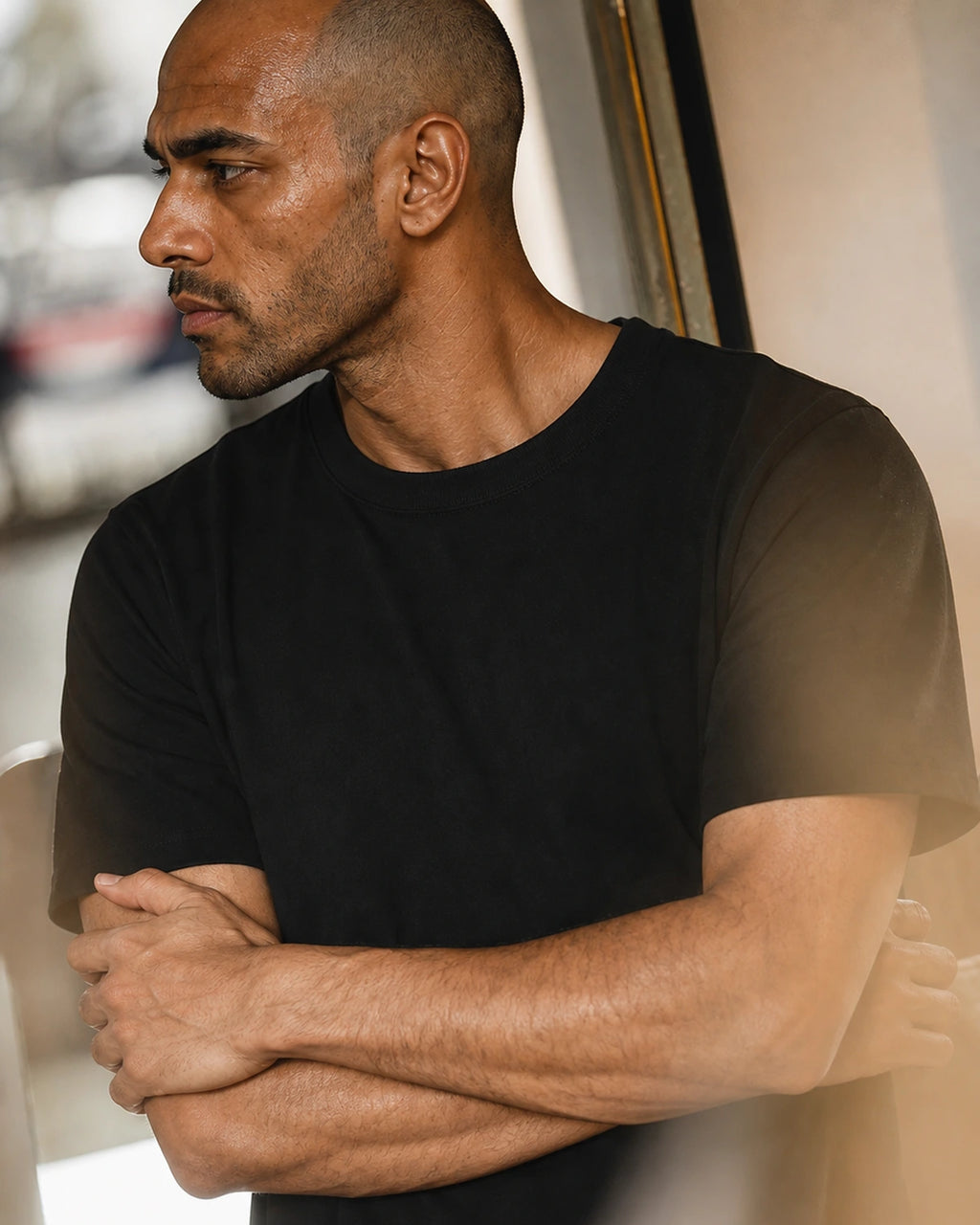 Man wearing the black heavyweight cotton t-shirt, side profile