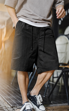 Men's carpenter shorts in black — front view on model