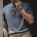 Close-up of a man wearing the cold gray henley with khaki trousers
