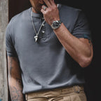 Close-up of a man wearing the cold gray henley with khaki trousers