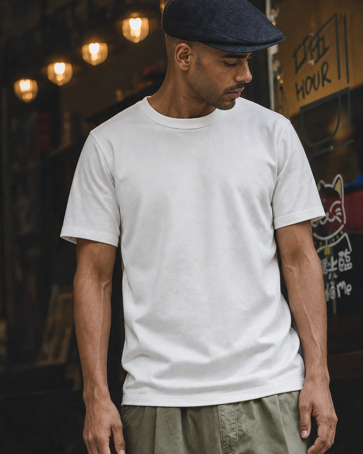 Man wearing the white heavyweight cotton t-shirt with light trousers, street scene