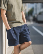 Man in MANLY navy cargo sweat shorts with olive tee — street look