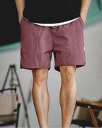 Washed burgundy retro training shorts with black tee — front crop
