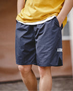 Navy retro training shorts with yellow tee — front crop