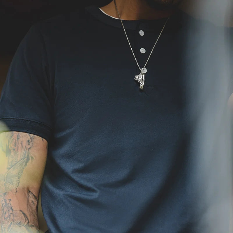 Close-up of the navy blue henley placket and neckline