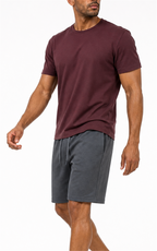 Model in burgundy tee walking in dark gray knit shorts