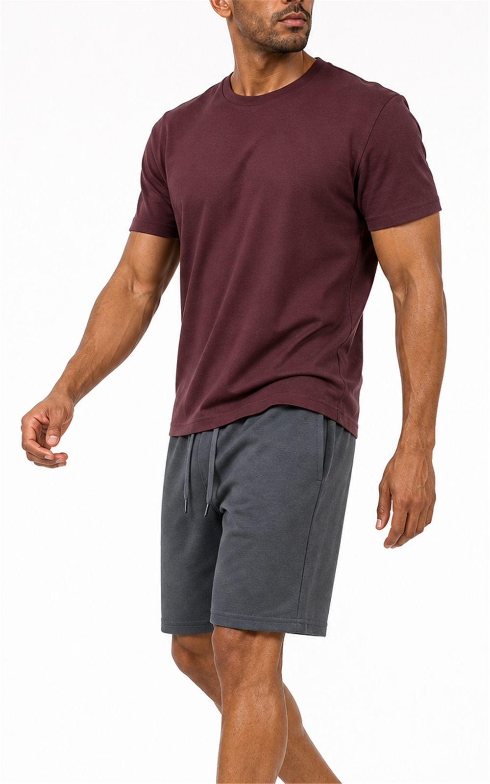 Model in burgundy tee walking in dark gray knit shorts