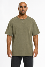 Man wearing the washed olive henley with black trousers, full view