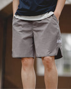 Grey PT-style shorts with navy tee — full front
