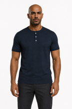 Man wearing the navy blue 3-button henley with dark trousers