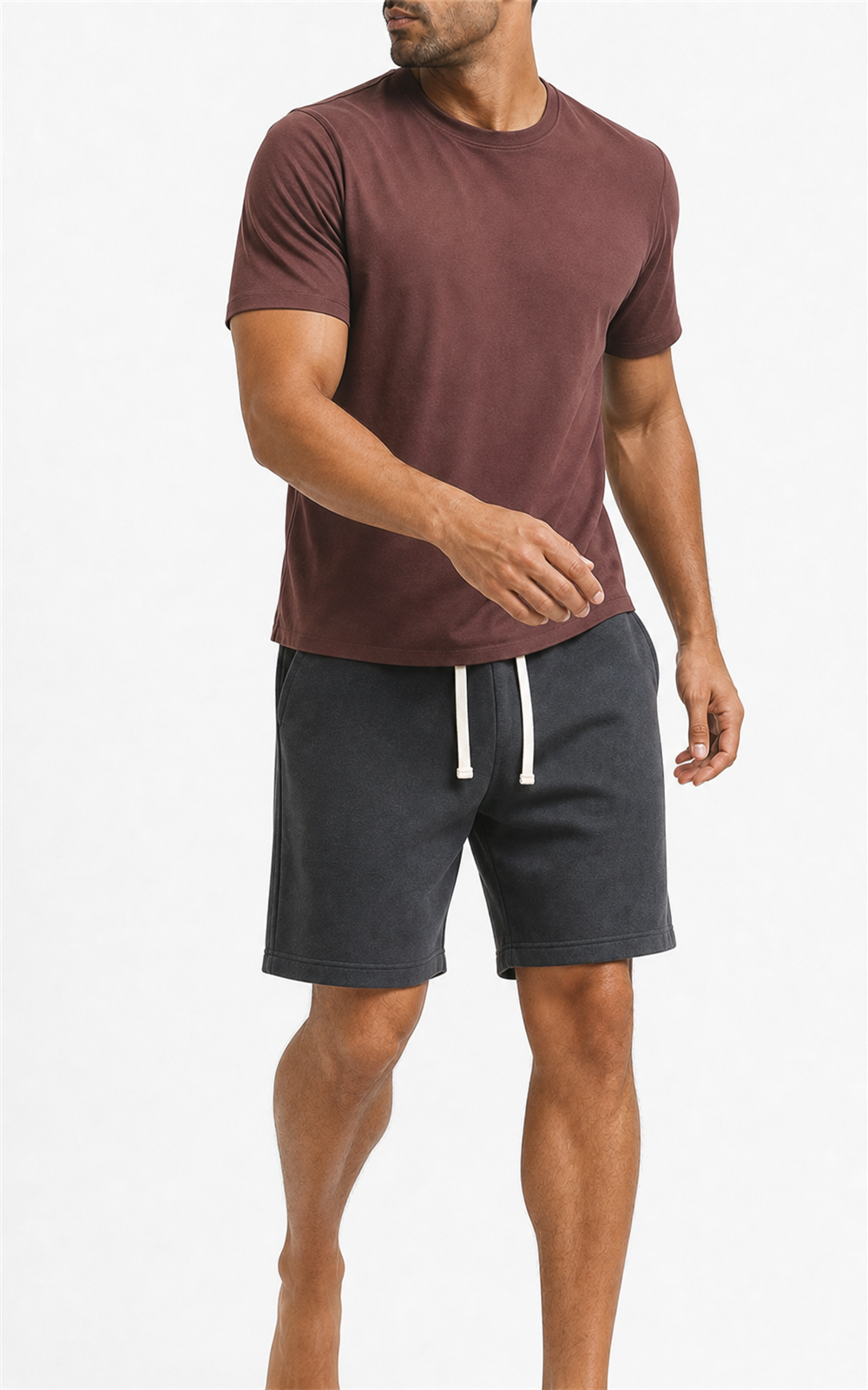 Model in burgundy tee walking in washed charcoal knit shorts