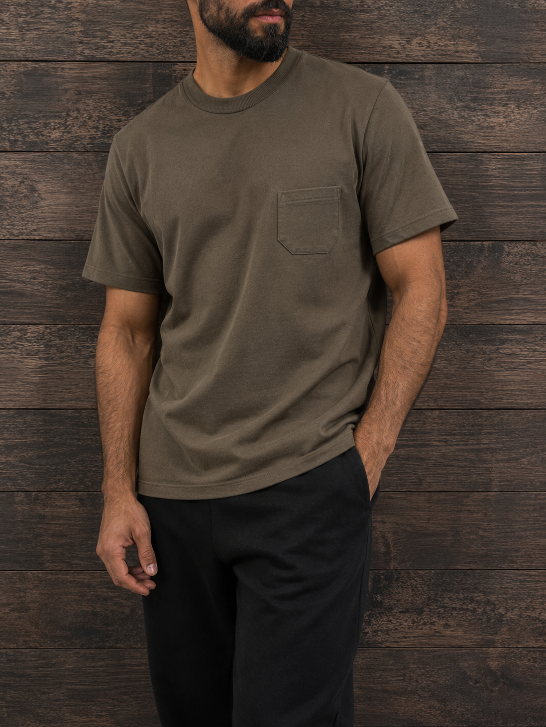 Man in the graphite green pocket tee with black trousers