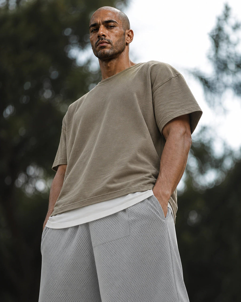 Low-angle: lead gray mesh shorts with taupe tee — outdoor