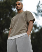 Low-angle: lead gray mesh shorts with taupe tee — outdoor