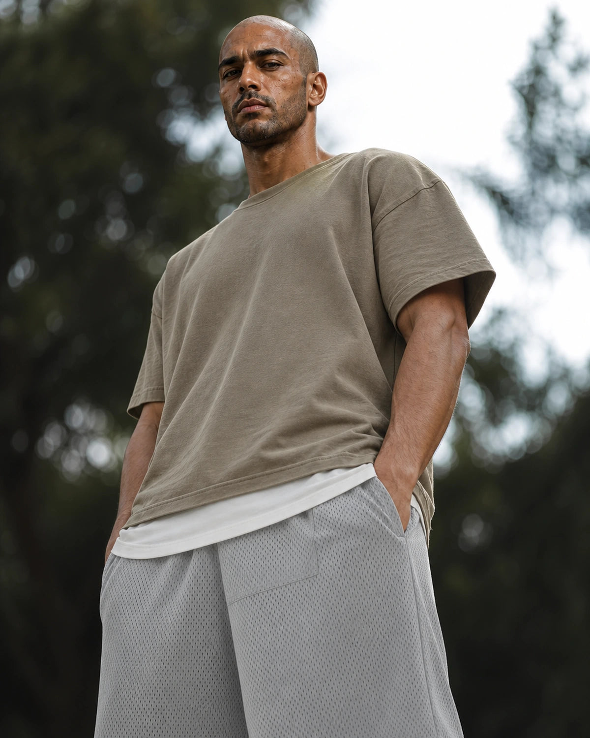 Low-angle: lead gray mesh shorts with taupe tee — outdoor
