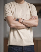 Man in the vintage apricot pocket tee with arms crossed