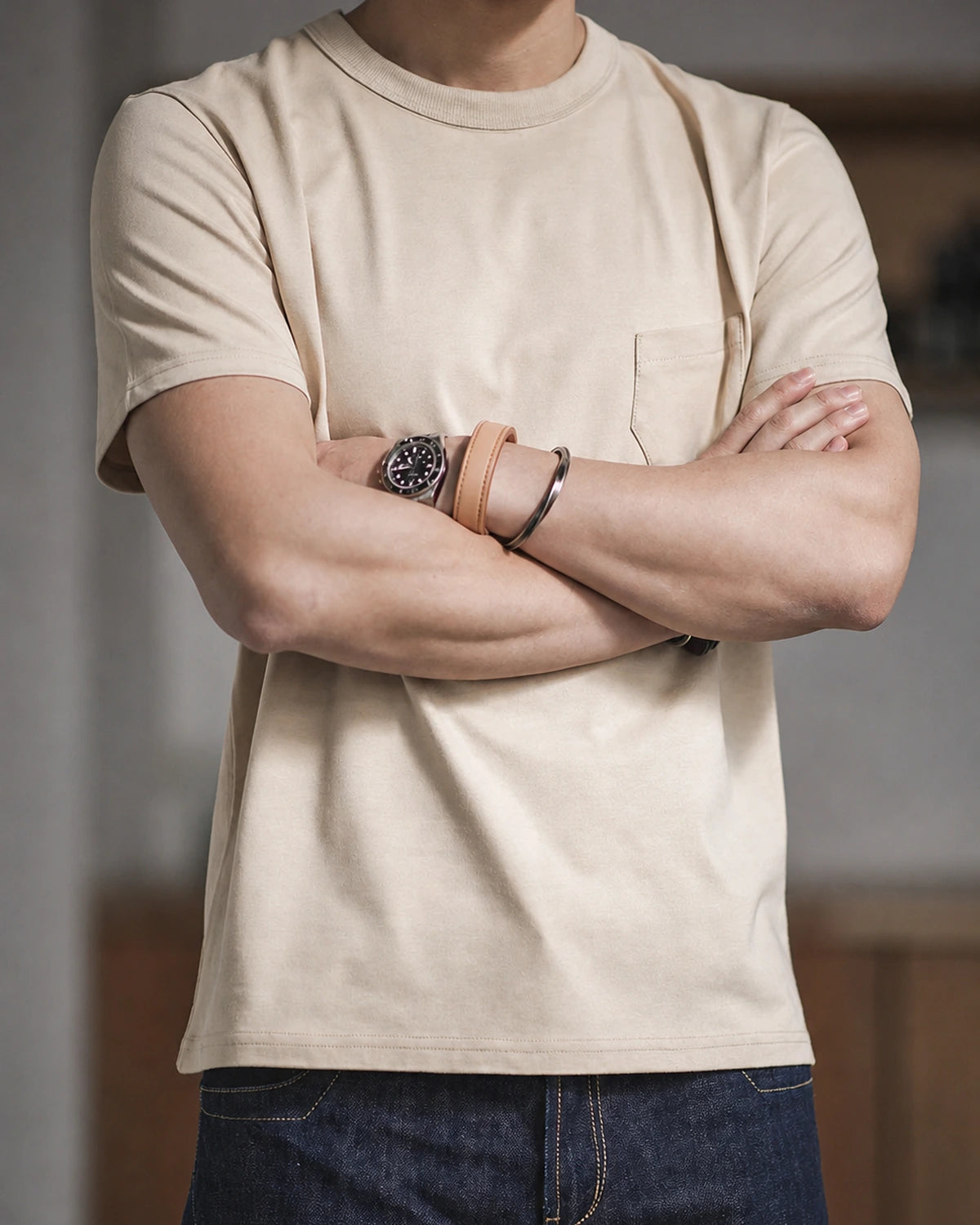 Man in the vintage apricot pocket tee with arms crossed