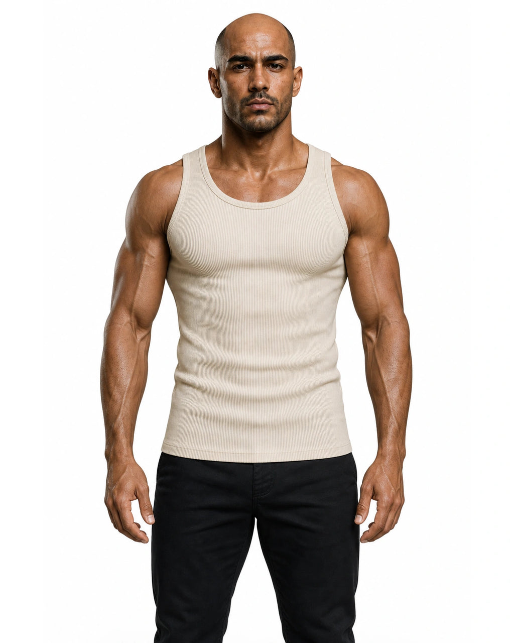 Man wearing the beige premium ribbed tank with black trousers