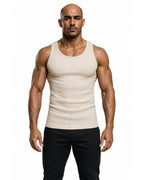Man wearing the beige premium ribbed tank with black trousers
