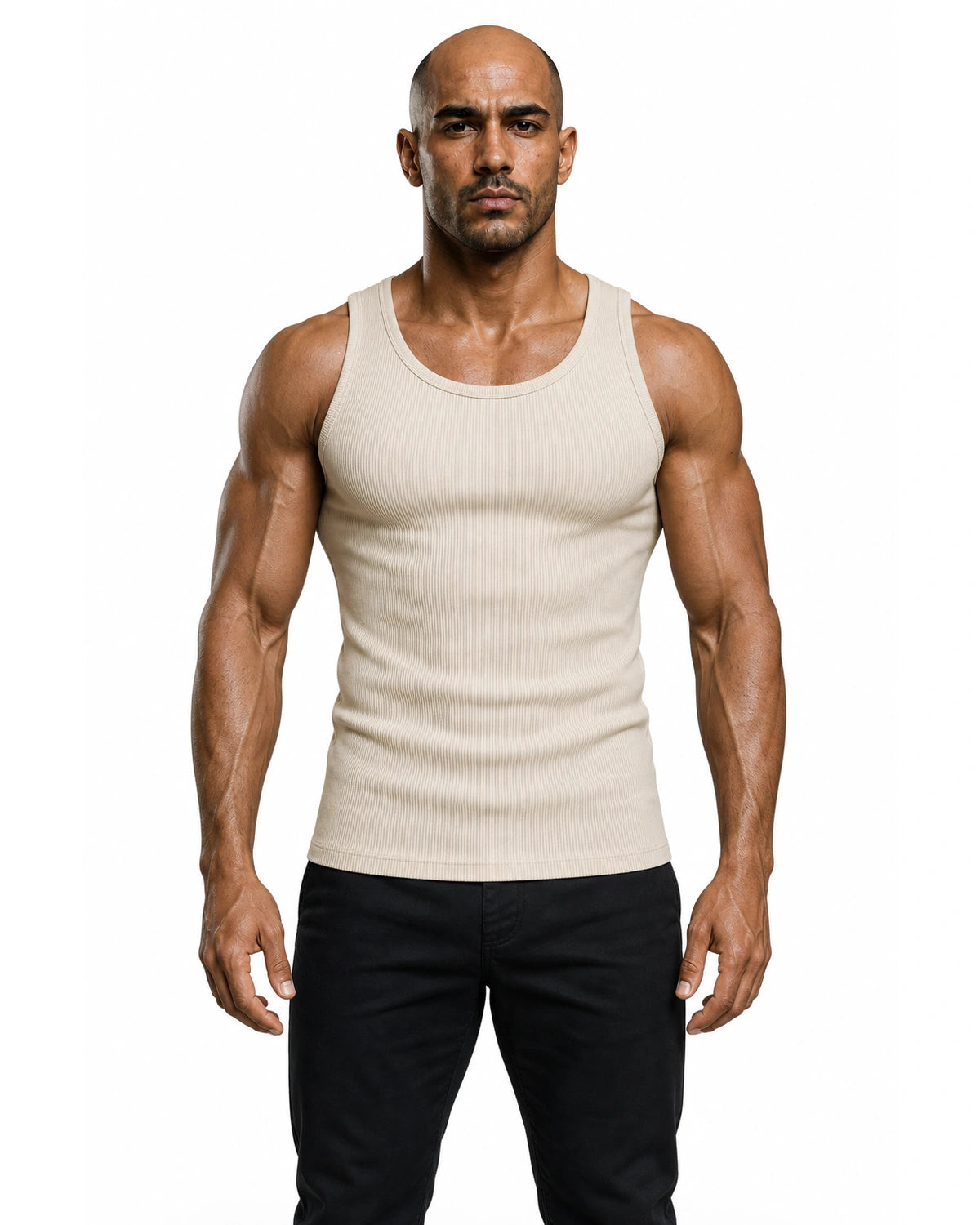 Man wearing the beige premium ribbed tank with black trousers