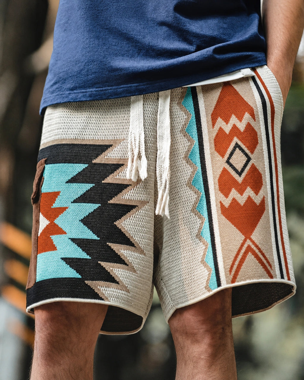 Woven geometric pattern on cream knit shorts — front detail