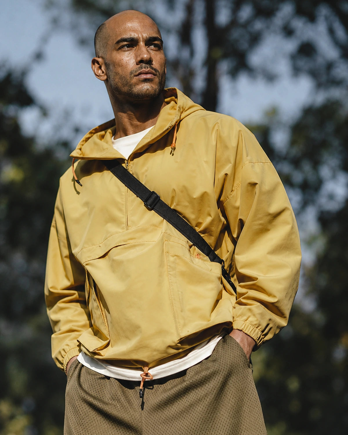 Man in yellow anorak and MANLY army green mesh shorts — outdoor portrait