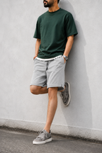 Lead gray mesh shorts with green tee — wall lean