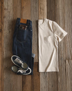 Flat lay of the pocket tee with jeans and sneakers