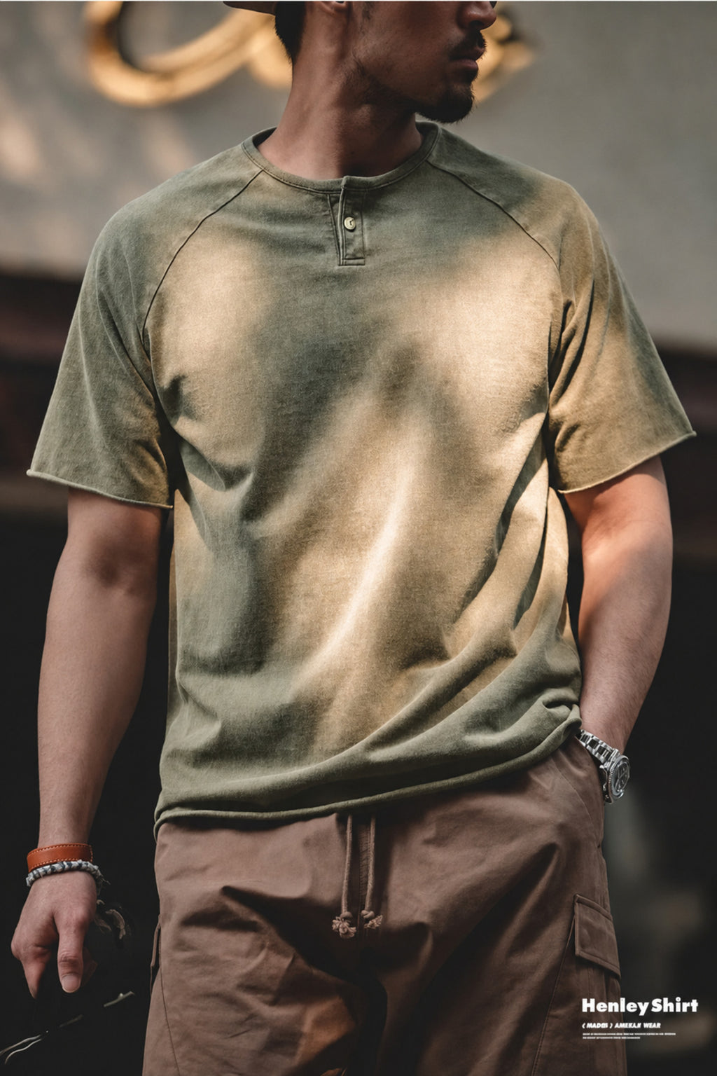 Man in the washed olive henley with brown shorts, fade variation visible