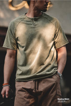 Man in the washed olive henley with brown shorts, fade variation visible