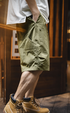 Side view: olive green carpenter shorts with large pocket