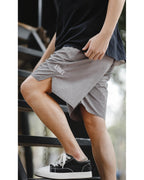 Grey retro shorts on stairs — side view with ARMY lettering