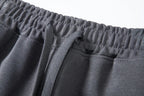 Close-up of dark gray shorts elastic waistband and flat drawcord