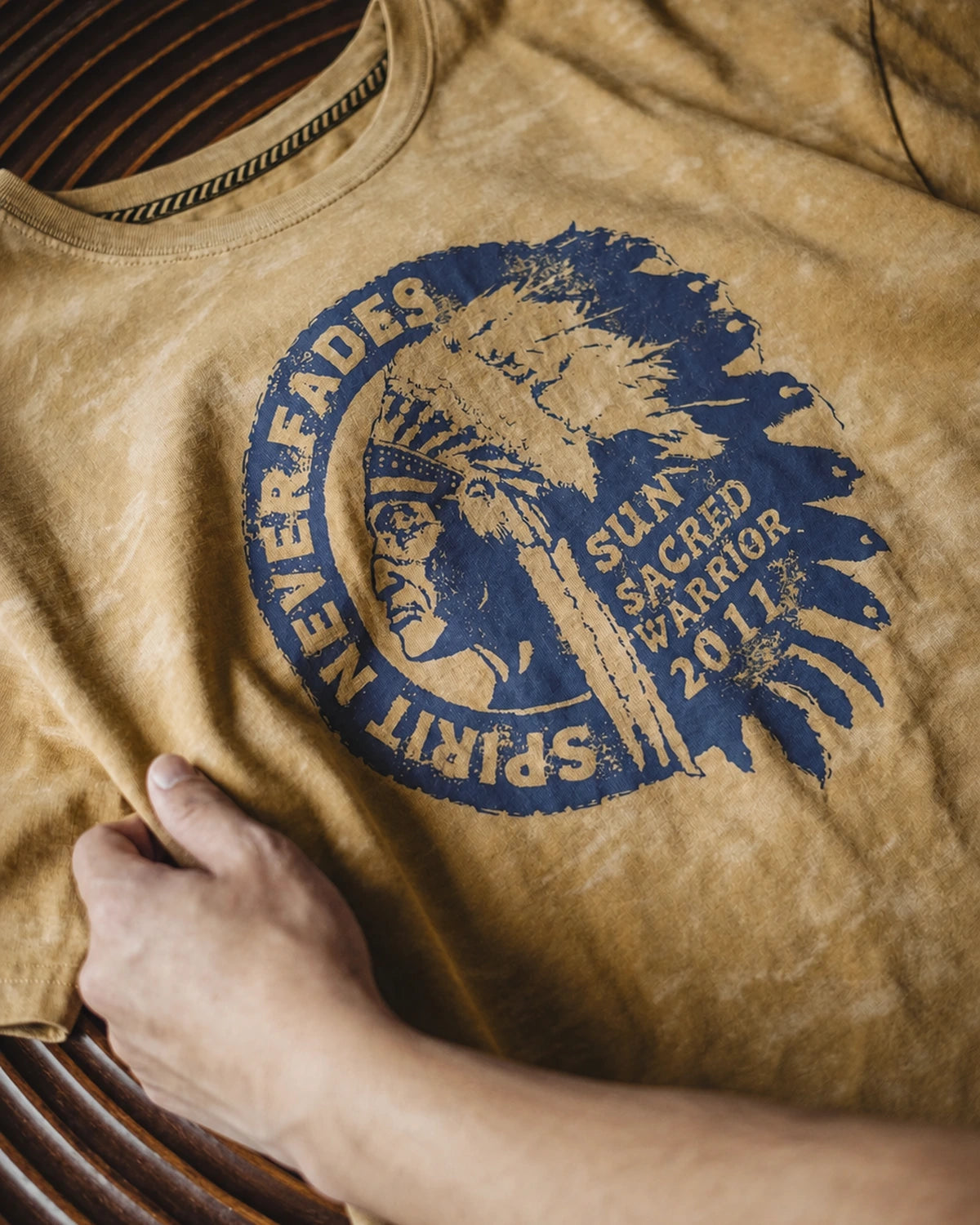 Close-up of the navy vintage Americana print on the washed mustard tee
