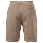 Back view of tan knit shorts with yoke seam and elastic waist