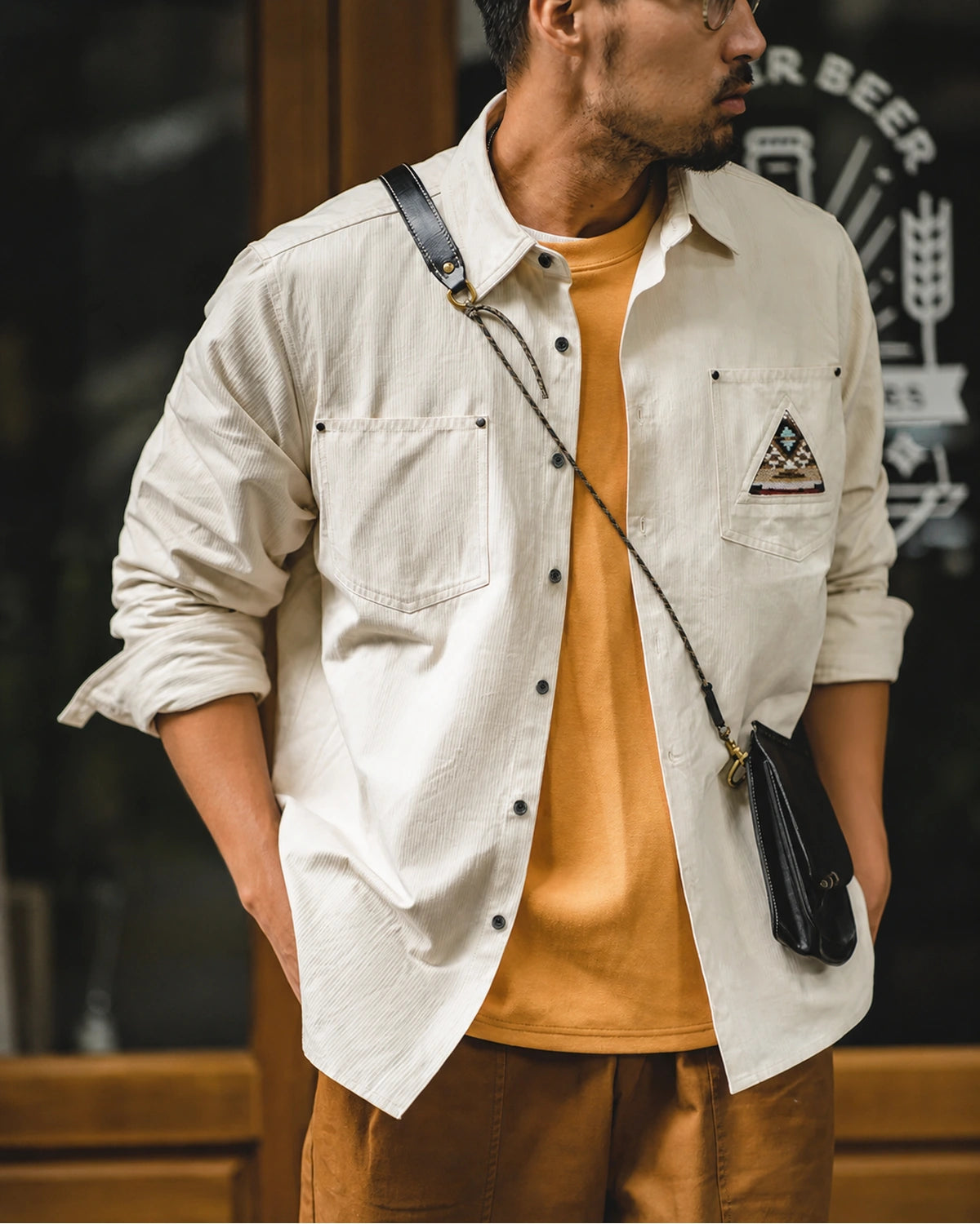 Man wearing the off-white overshirt open over a mustard tee