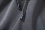 Detail of braided drawcords with black tips on dark gray shorts