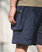 Washed cotton knit texture and button flap — detail