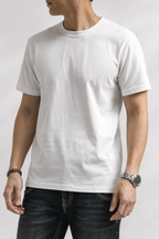 White heavyweight cotton t-shirt worn with dark jeans, front torso view