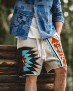 Full look: tapestry shorts with denim overshirt on log wall