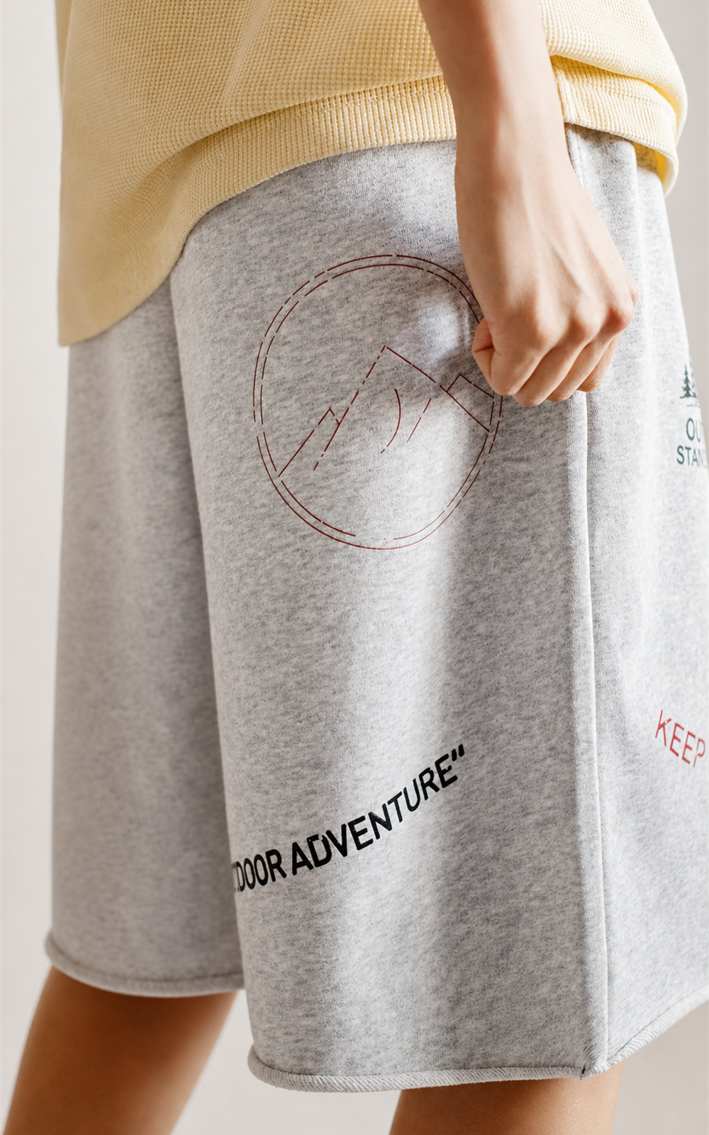 Circle mountain print and Outdoor Adventure text on grey knit shorts