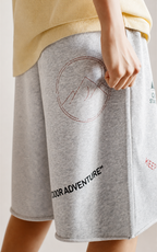 Circle mountain print and Outdoor Adventure text on grey knit shorts