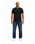 Man wearing the black heavyweight tee with blue jeans, full view