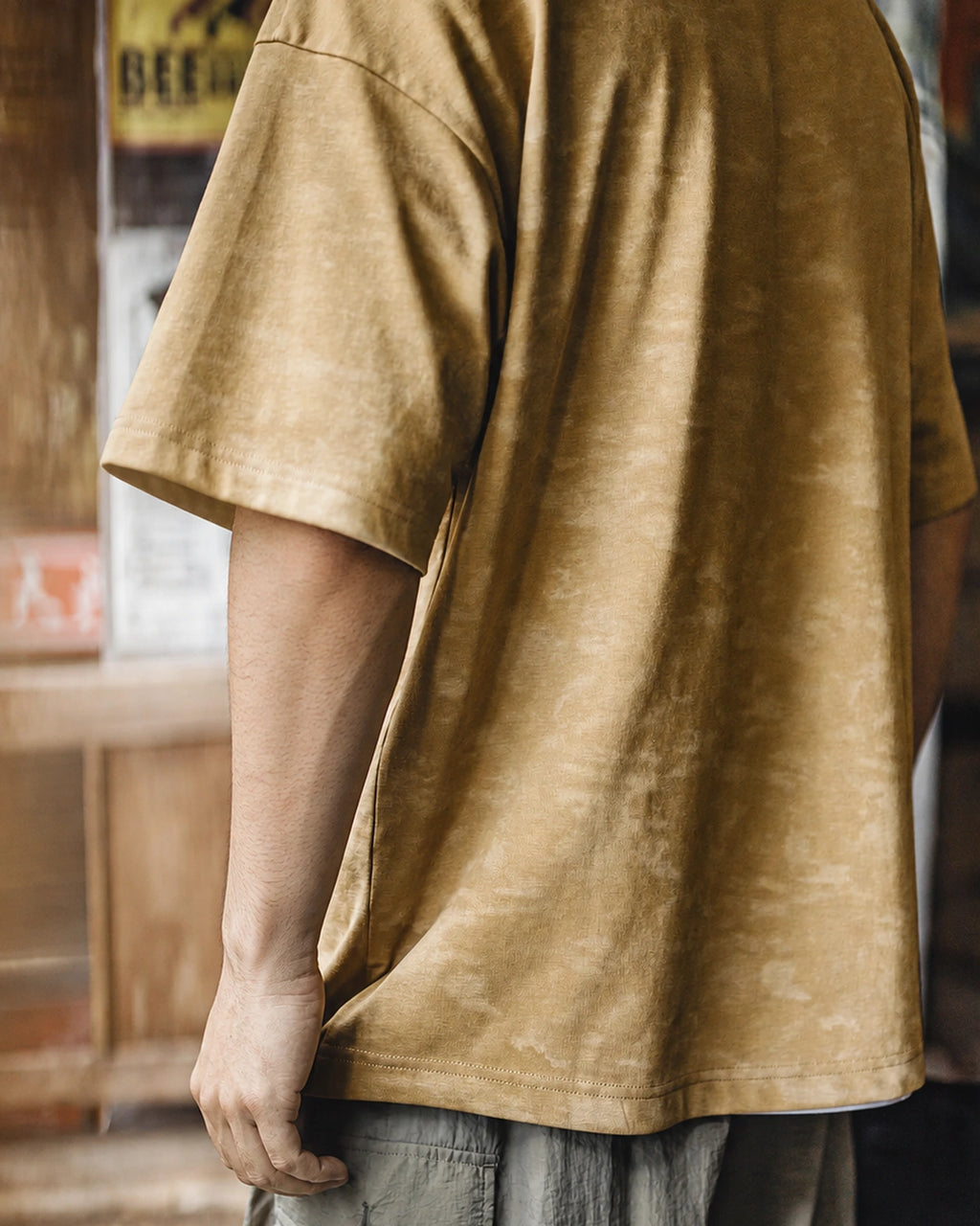 Side view showing the mineral wash texture and drop-shoulder cut