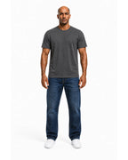 Man wearing the grey heavyweight tee with blue jeans, full view