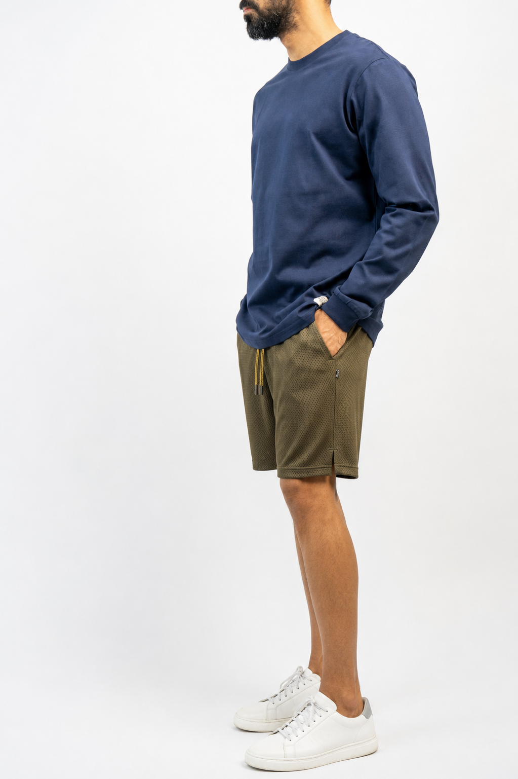 Side view: army green mesh shorts with navy long-sleeve