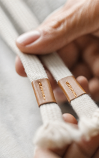 Leather-tipped drawstrings on grey sweat shorts — detail
