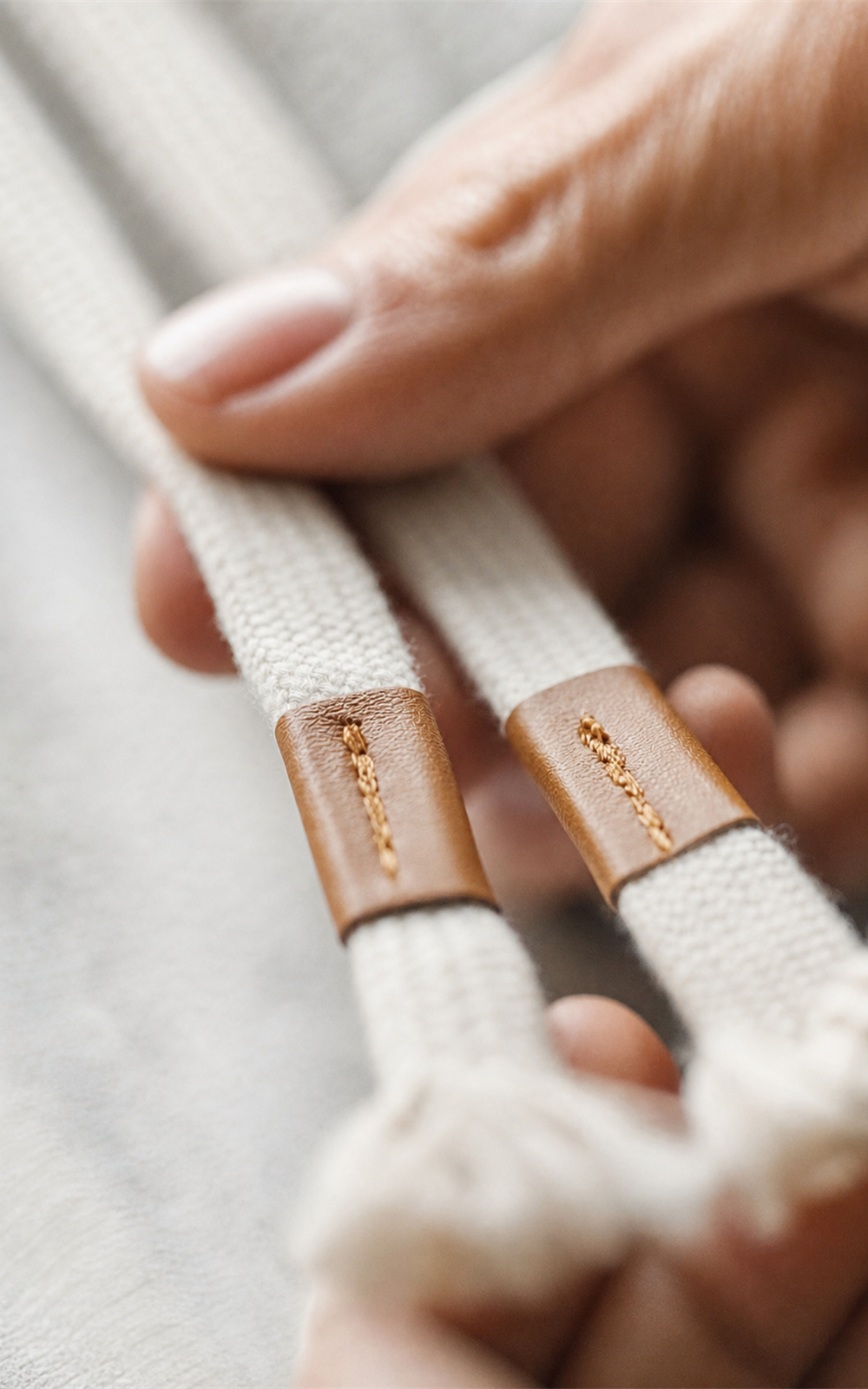 Leather-tipped drawstrings on grey sweat shorts — detail