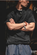 Man with arms crossed in the washed black henley